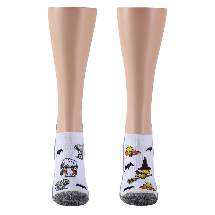 White and black marled ankle compression socks with Peanuts Halloween designs, shown from the front.