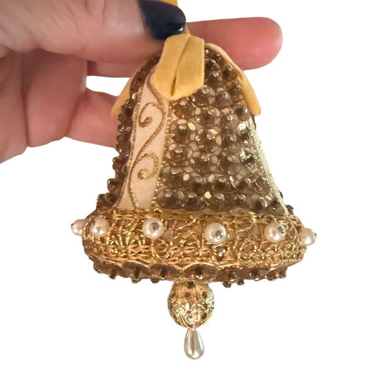 Vintage gold and ivory bell ornament with sequins, pearl-look trim, a yellow ribbon loop, and a dangling teardrop.
